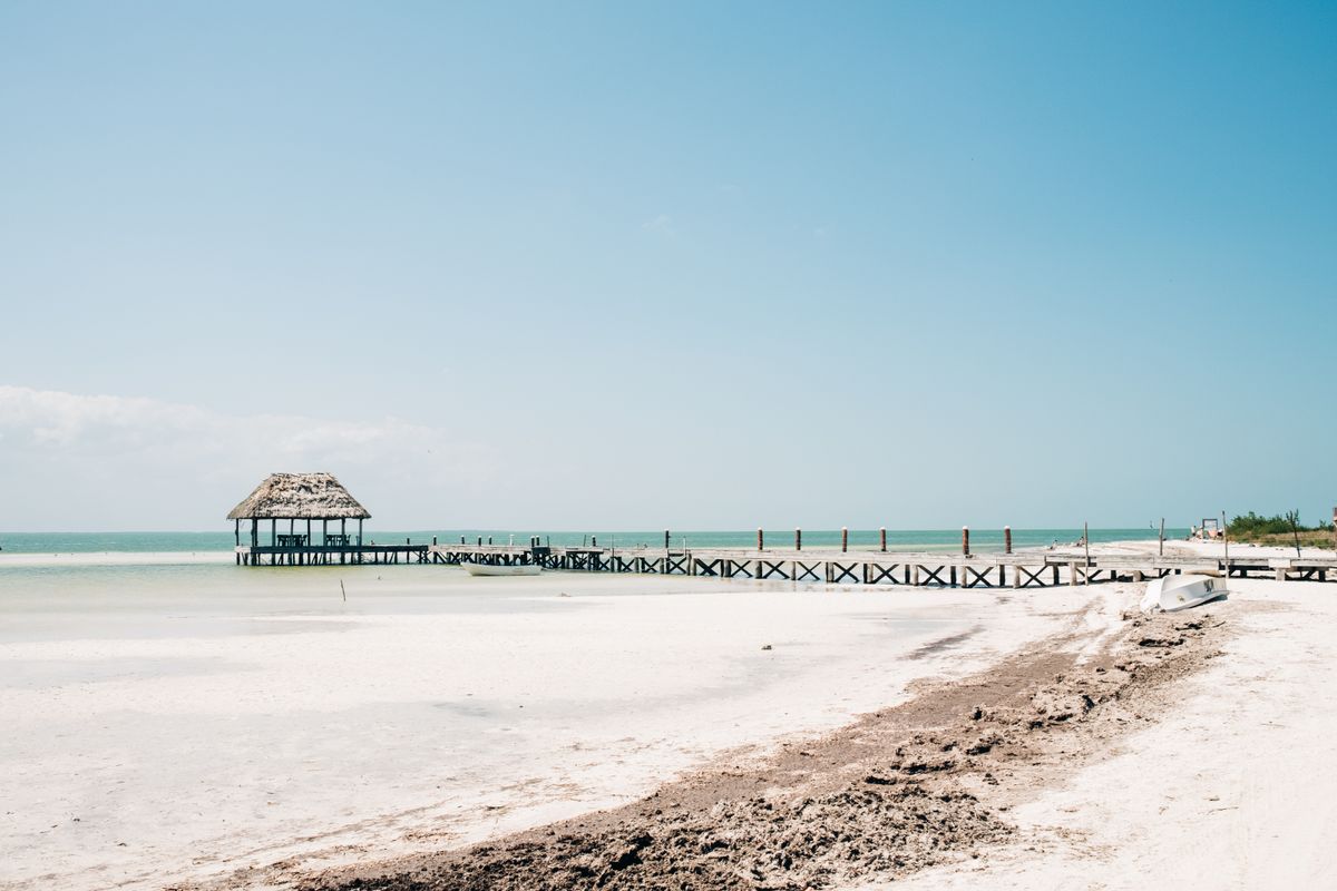 White-sand beach and palapa pier on Isla Holbox